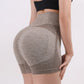 Woman wearing seamless high-waisted workout shorts in a slim, stretchy fit—ideal for yoga, gym, and activewear.