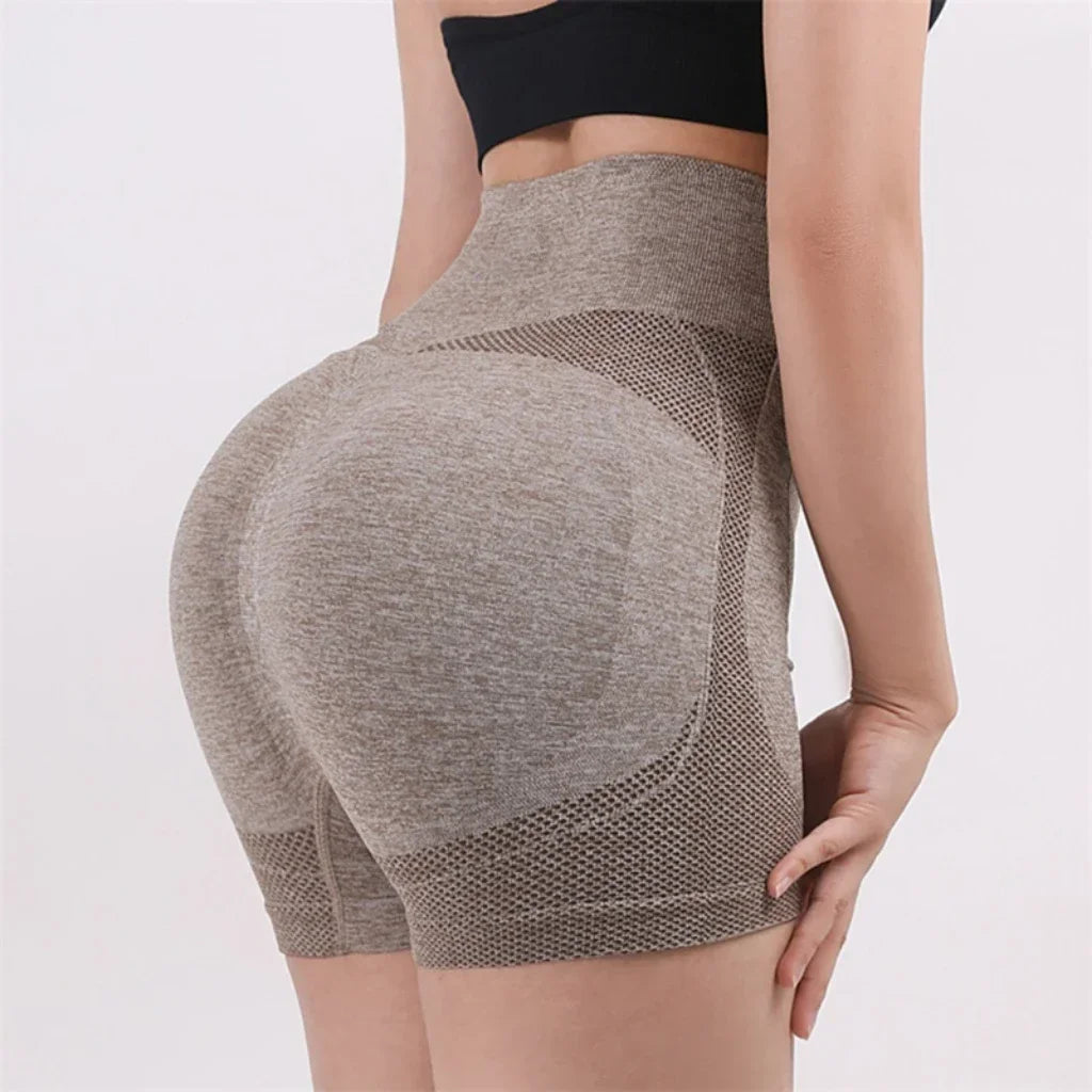 Woman wearing seamless high-waisted workout shorts in a slim, stretchy fit—ideal for yoga, gym, and activewear.