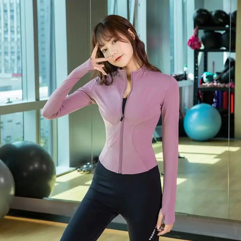 Woman wearing pink sleek fit yoga jacket for workouts and summer jogging