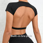 Woman wearing a black backless workout crop top with breathable, stretchy fabric — perfect for running, gym workouts, cycling, and outdoor activities.