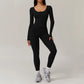 Woman wearing black open-back summer jumpsuit with long sleeves and full-length legs.