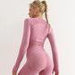 Woman wearing a long-sleeve yoga crop top with a built-in bra in pink—perfect for workouts, yoga sessions, or summer activewear.