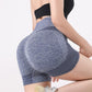 Woman wearing seamless high-waisted workout shorts in a slim, stretchy fit—ideal for yoga, gym, and activewear.