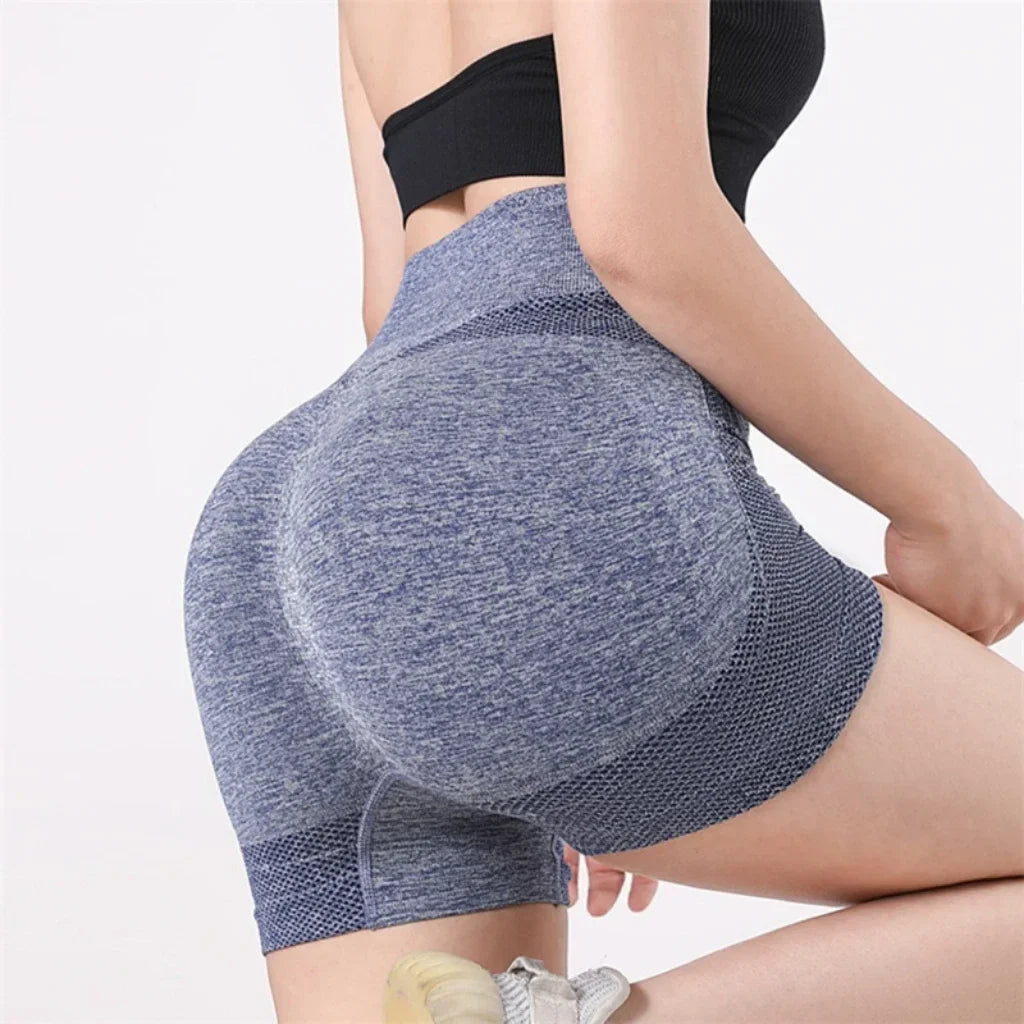Woman wearing seamless high-waisted workout shorts in a slim, stretchy fit—ideal for yoga, gym, and activewear.