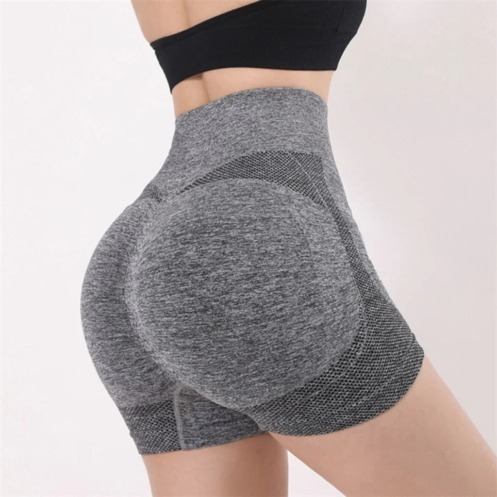 Woman wearing seamless high-waisted workout shorts in a slim, stretchy fit—ideal for yoga, gym, and activewear.