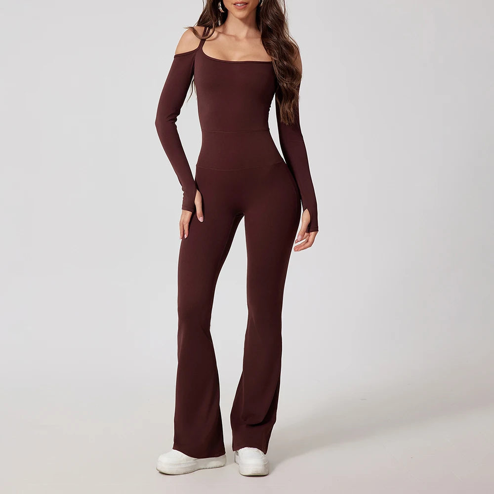 Woman wearing brown open-back summer jumpsuit with long sleeves and full-length legs.