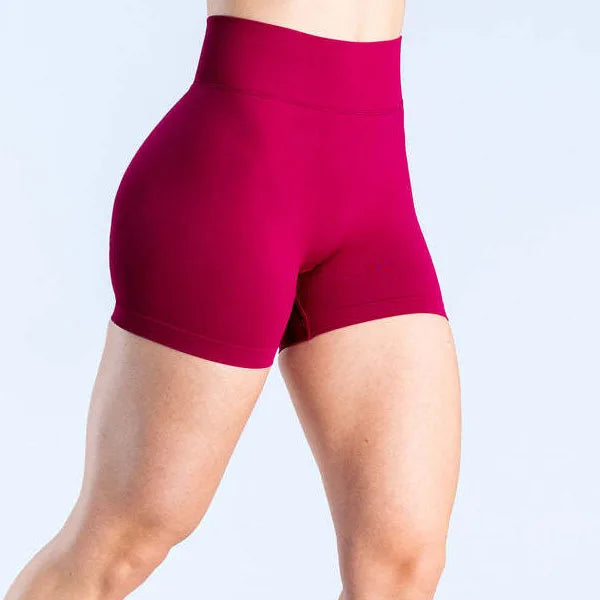 woman wearing a red soft, breathable yoga shorts in a high-waisted fit—perfect for workouts, yoga, or relaxed summer days.