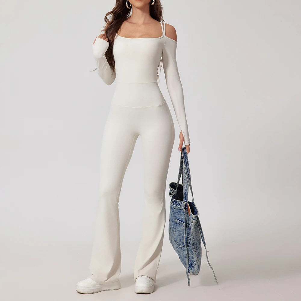 Woman wearing white open-back summer jumpsuit with long sleeves and full-length legs.