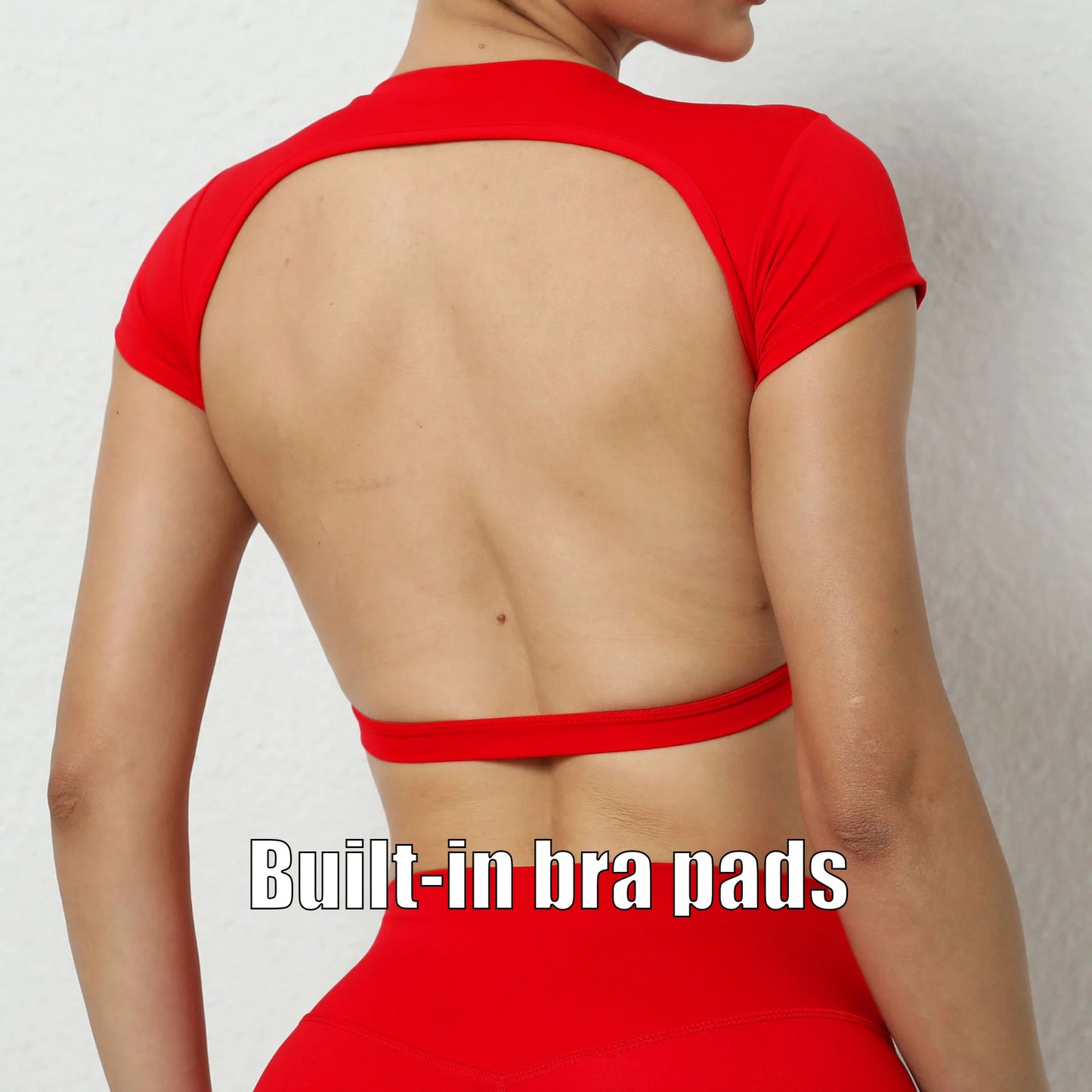 Woman wearing a red backless workout crop top with breathable, stretchy fabric — perfect for running, gym workouts, cycling, and outdoor activities.