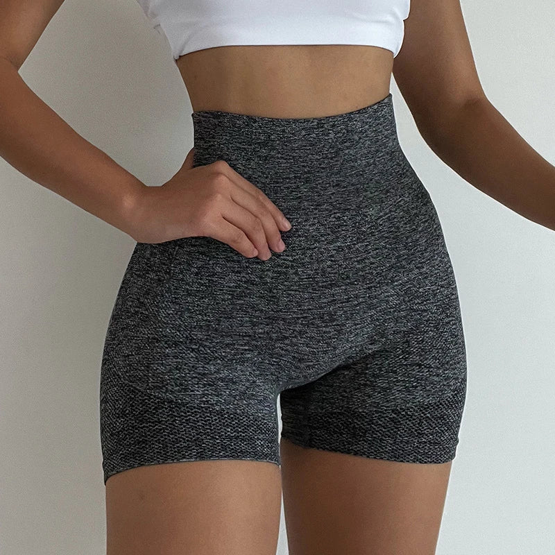Woman wearing seamless high-waisted workout shorts in a slim, stretchy fit—ideal for yoga, gym, and activewear.