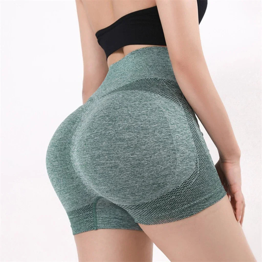 Woman wearing seamless high-waisted workout shorts in a slim, stretchy fit—ideal for yoga, gym, and activewear.