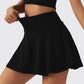 Woman wearing white high-waist skort with hidden pocket and built-in shorts