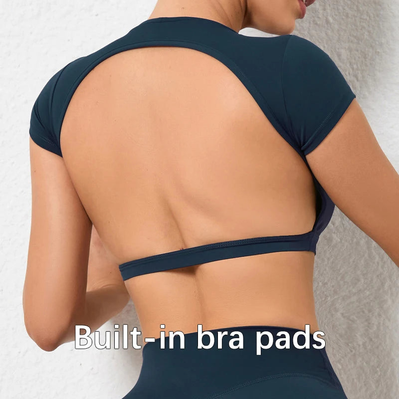 Woman wearing a backless workout crop top with breathable, stretchy fabric — perfect for running, gym workouts, cycling, and outdoor activities.