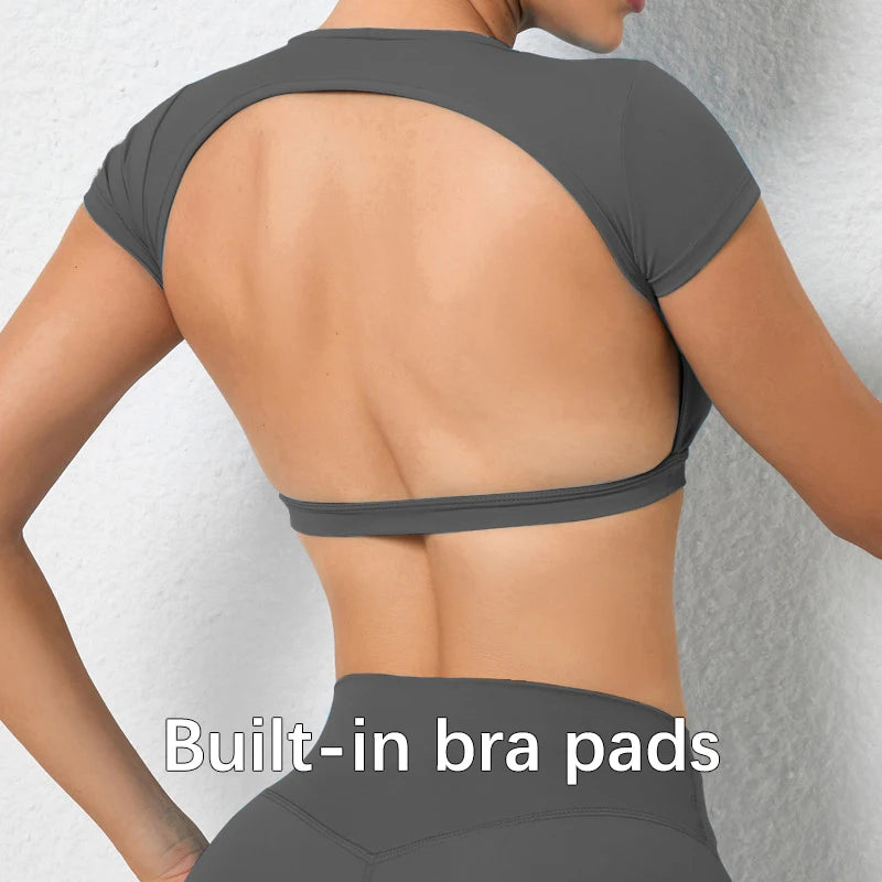 Woman wearing a backless workout crop top with breathable, stretchy fabric — perfect for running, gym workouts, cycling, and outdoor activities.