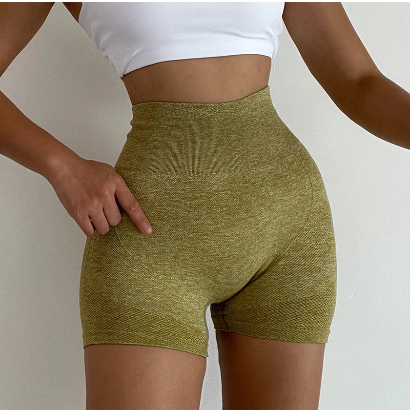 Woman wearing seamless high-waisted workout shorts in a slim, stretchy fit—ideal for yoga, gym, and activewear.