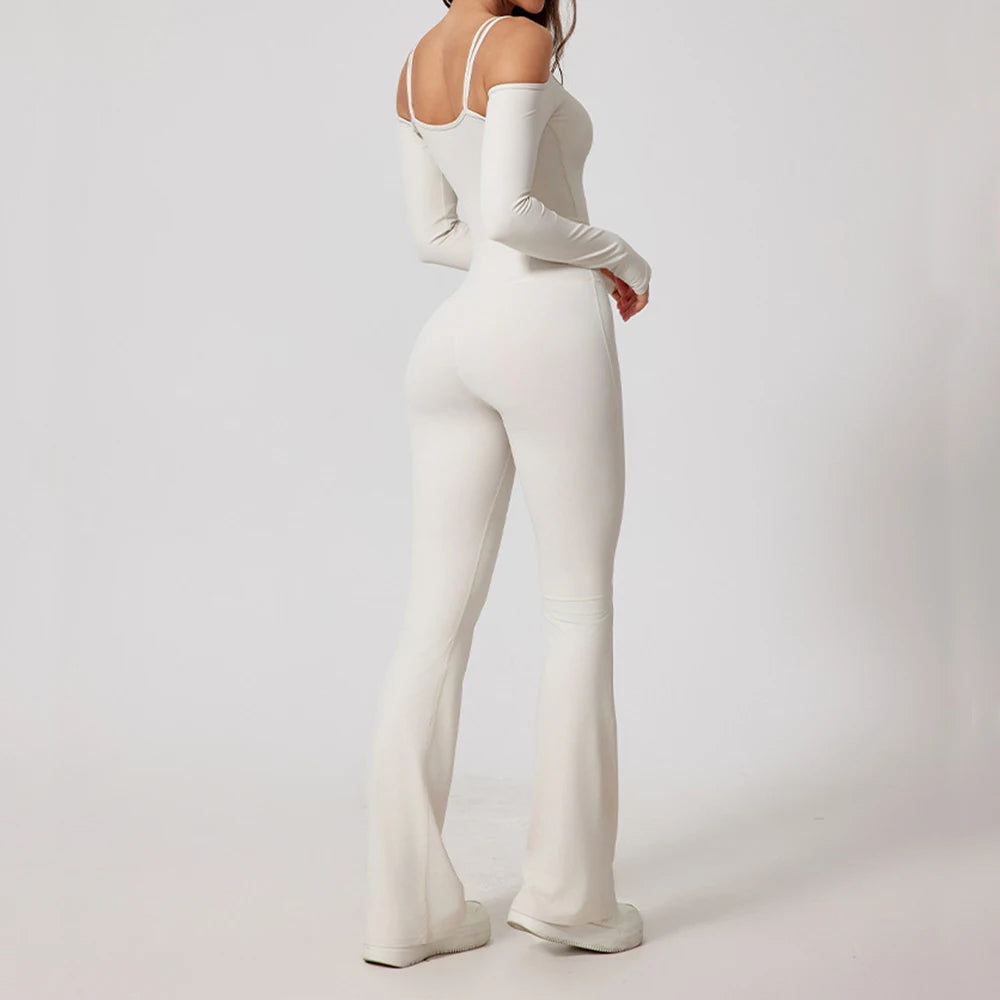 Woman wearing white open-back summer jumpsuit with long sleeves and full-length legs.