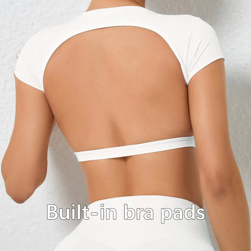 Woman wearing a white backless workout crop top with breathable, stretchy fabric — perfect for running, gym workouts, cycling, and outdoor activities.