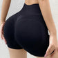 Woman wearing seamless high-waisted workout shorts in a slim, stretchy fit—ideal for yoga, gym, and activewear.